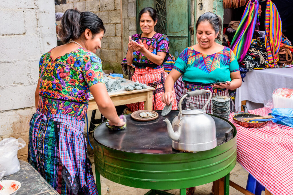 Local women make tortillas in the street, Santiago Sacatepequez, Guatemala